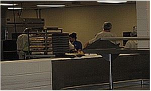 Image of jail kitchen showing food trays being served